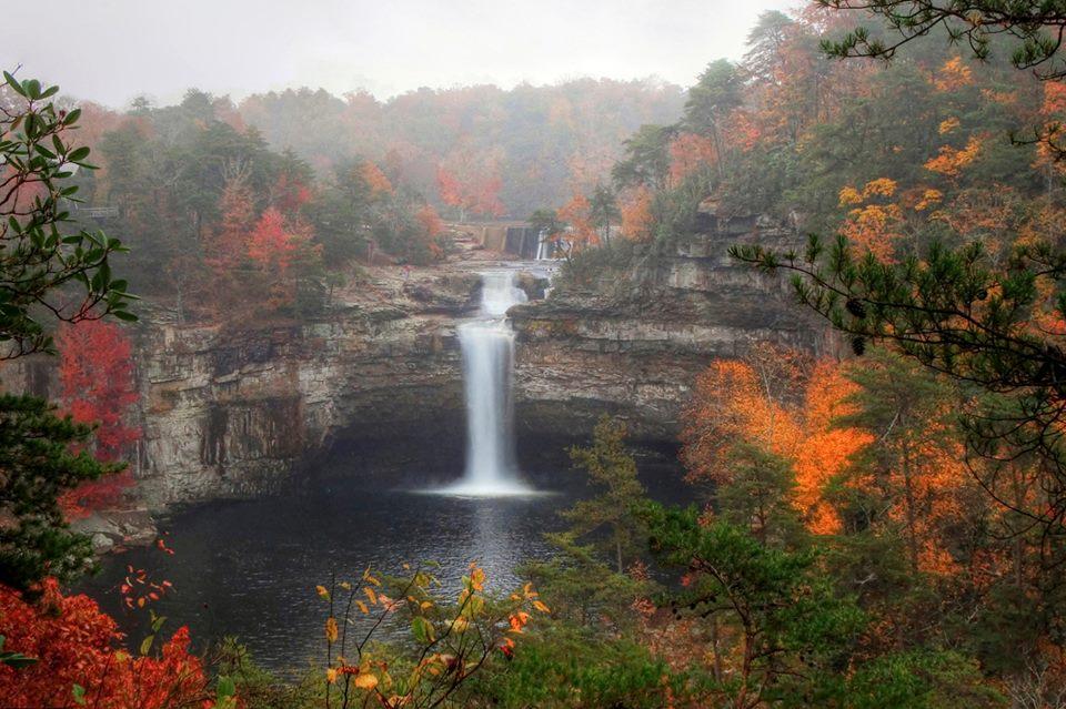 DeSoto State Park waterfall with colorful fall leaves taken from a fun hiking outdoor activity.