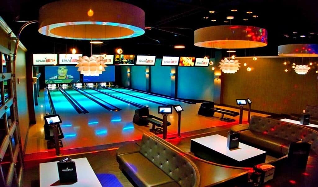 A view of bowling lanes and seats for fun indoor activities at Spare Time Entertainment.